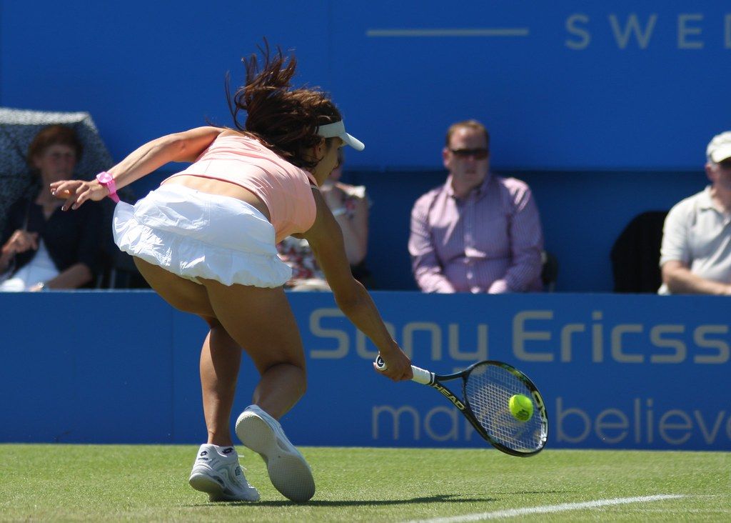 A player stretches for a wide ball at a WTA tournament
