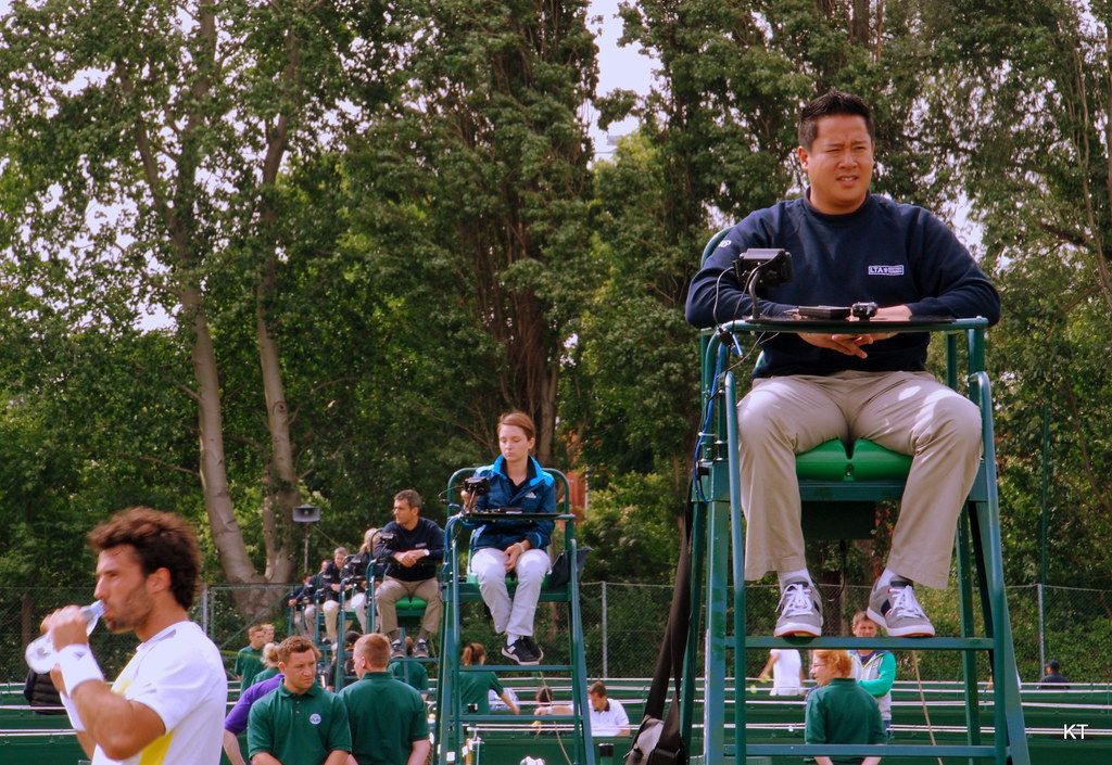 Chair umpire watching a match at a grass-court event
