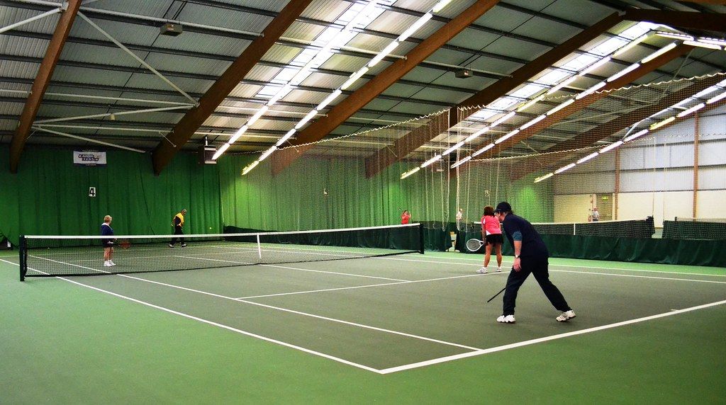 Doubles match in an indoor tennis centre
