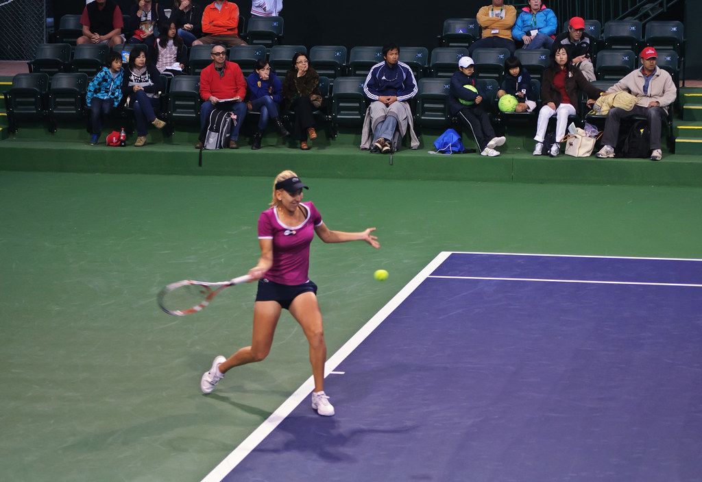 A match on a hard court with spectators in the stands